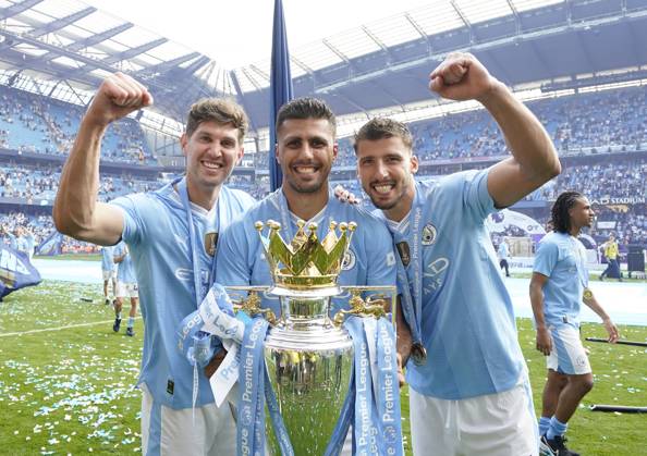 Manchester, England, 19th May 2024. Rodri of Manchester City (C), John Stones of Manchester City (L) and Ruben Dias of Manchester City celebrate with the Premier league trophy during the Premier League match at the Etihad Stadium, Manchester. Picture credit should read: Andrew Yates Sportimage EDITORIAL USE ONLY. No use with unauthorised audio, video, data, fixture lists, club league logos or live services. Online in-match use limited to 120 images, no video emulation. No use in betting, games or single club league player publications. SPI-3159-0020