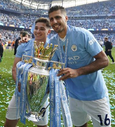 Manchester, England, 19th May 2024. Rodri of Manchester City (R) and Julian Alvarez of Manchester City celebrate with the Premier league trophy during the Premier League match at the Etihad Stadium, Manchester. Picture credit should read: Andrew Yates Sportimage EDITORIAL USE ONLY. No use with unauthorised audio, video, data, fixture lists, club league logos or live services. Online in-match use limited to 120 images, no video emulation. No use in betting, games or single club league player publications. SPI-3159-0071
