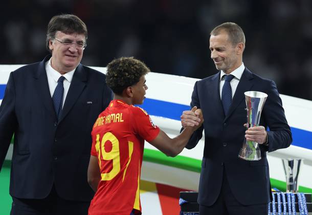 Berlin, Germany, 14th July 2024. Lamine Yamal of Spain shakes hands with Aleksander Ceferin, President of UEFA as he collects his young player of the tournament trophy during the UEFA European Championships final match at Olympiastadion, Berlin. Picture: Paul Terry Sportimage EDITORIAL USE ONLY. No use with unauthorised audio, video, data, fixture lists, club league logos or live services. Online in-match use limited to 120 images, no video emulation. No use in betting, games or single club league player publications. SPI-3227-0323