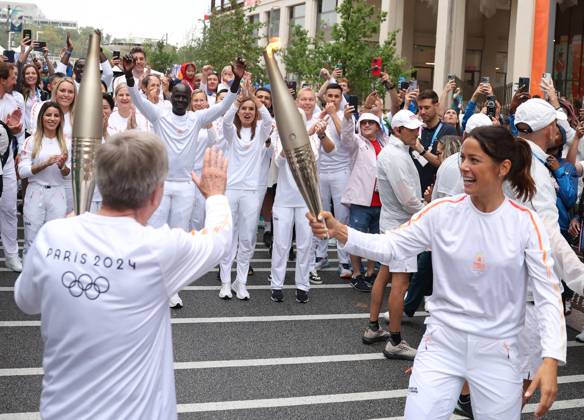(240726) -- PARIS, July 26, 2024 -- International Olympic Committee (IOC) President Thomas Bach (L) and France s handball player Cleopatre Darleux take part in the Olympic Village torch relay in the Olympic Village in Paris, France, July 26, 2024. (Photo by POOL Xinhua) (PARIS2024)FRANCE-PARIS Olympic Games, Olympische Spiele, Olympia, OS TORCH RELAY JiaxHaocheng