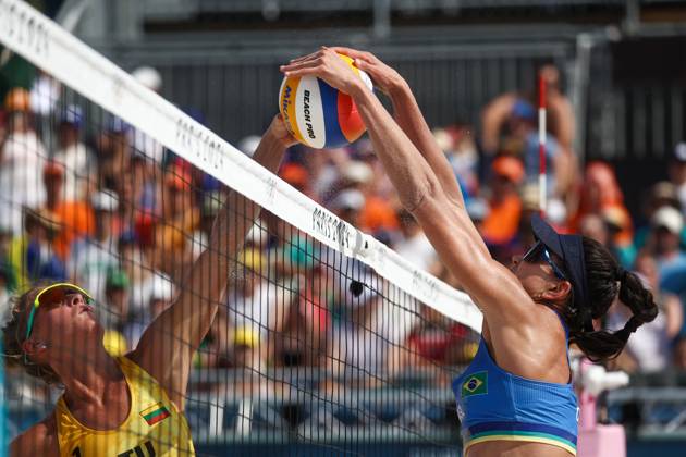 RUSSIA, PARIS - JULY 30, 2024: Lithuania s Monika Paulikene (L) and Brazil s Carolina Solberg Salgado play a womenâ€™s Pool E Beach volleyball, Beachvolleyball match during the 2024 Summer Olympics at the Eiffel Tower Stadium on the Champ de Mars. Alexander Shcherbak TASS  72546813