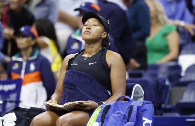 Naomi Osaka flips through pages of a journal during a changeover in her match against Karolina Muchova in the second round in Arthur Ashe Stadium of the 2024 US Open Tennis Championships in at the USTA Billie Jean King National Tennis Center on Thursday, August 29, 2024 in New York City.  NYP20240829113 JOHNxANGELILLO