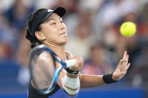 (241012) -- WUHAN, Oct. 12, 2024 -- Wang Xinyu hits a return during the women s singles semifinal match between Zheng Qinwen of China and Wang Xinyu of China at the 2024 Wuhan Open tennis tournament in Wuhan, central China s Hubei Province, Oct. 12, 2024. ) (SP)CHINA-WUHAN-TENNIS-WUHAN OPEN-WOMEN S SINGLES (CN) XiaoxYijiu