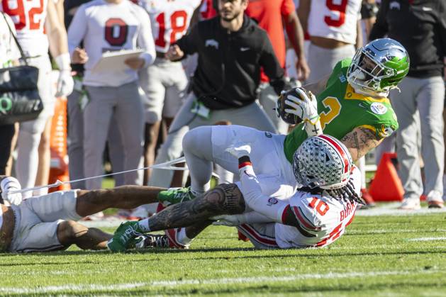 January 1, 2025, Los Angeles, California, United States: Oregon tight end Terrance Ferguson 3 is tackled by Ohio State cornerbacks Jordan Hancock 7 and Denzel Burke 10 during the 2025 Rose Bowl game Wednesday, Jan. 1, 2024, in Pasadena, Calif. Los Angeles USA - ZUMAc68_ 20250101_zaf_c68_019 Copyright: xRingoxChiux