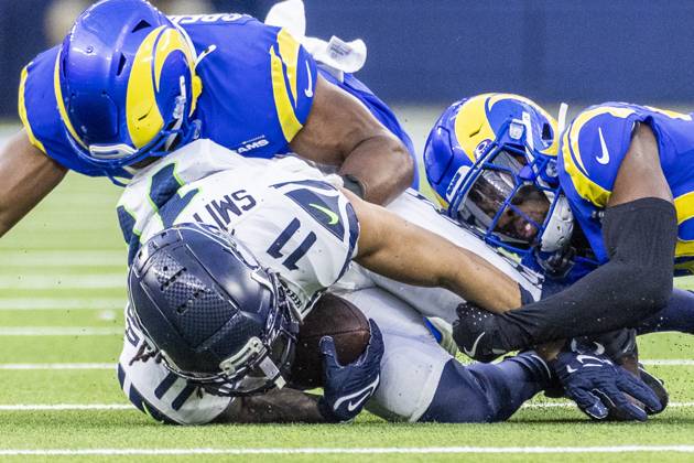 January 5, 2025, Los Angeles, California, United States: Seattle Seahawks wide receiver Jaxon Smith-Njigba 11 is brought down by Los Angeles Rams cornerback Josh Wallace (L) and Los Angeles Rams inside linebacker Omar Speights (R) during an NFL, American Football Herren, USA football game at SoFi Stadium. Final Score : Seattle Seahawks 30:25 Los Angeles Rams Los Angeles United States - ZUMAs197 20250105_aaa_s197_232 Copyright: xRingoxChiux