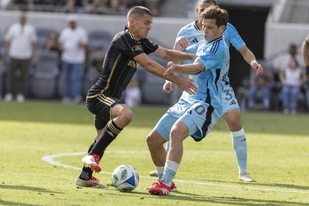 February 22, 2025, Los Angeles, California, United States: Los Angeles FC s Sergi Palencia 14 and Minnesota United s Wil Trapp 20 vie for the ball during an MLS, Fussball Herren, USA soccer match at BMO Stadium. Final score; Los Angeles FC 1:0 Minnesota United FC Los Angeles United States - ZUMAs197 20250222_aaa_s197_319 Copyright: xRingoxChiux
