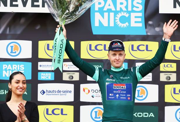 Belgian Tim Merlier of Soudal Quick-Step celebrates on the podium in the green jersey of leader in the sprint ranking after stage three of the 83th edition of the Paris-Nice cycling race, a 28,4km team time trial at the Nevers Magny-Cours racetrack, in Nevers, France, Tuesday 11 March 2025. DAVIDxPINTENS  x114684909x