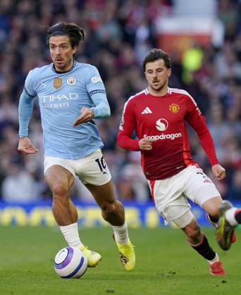 Manchester, England, 6th April 2025. Jack Grealish of Manchester City runs ahead of Mason Mount of Manchester United, ManU during the Manchester United vs Manchester City Premier League match at Old Trafford, Manchester. Picture credit should read: Andrew Yates Sportimage EDITORIAL USE ONLY. No use with unauthorised audio, video, data, fixture lists, club league logos or live services. Online in-match use limited to 120 images, no video emulation. No use in betting, games or single club league player publications. SPI_043_AY_United_City SPI-3814-0044