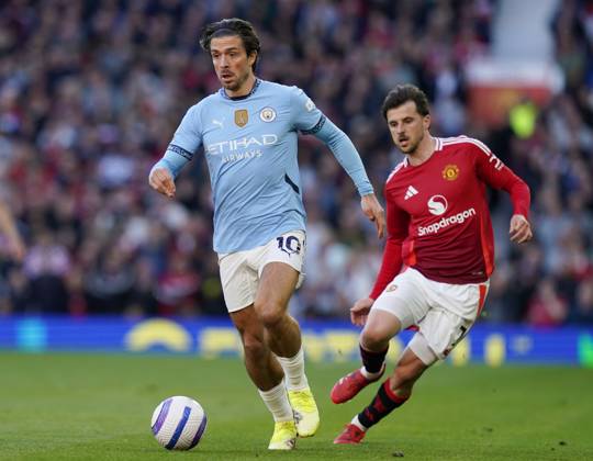 Manchester, England, 6th April 2025. Jack Grealish of Manchester City runs ahead of Mason Mount of Manchester United, ManU during the Manchester United vs Manchester City Premier League match at Old Trafford, Manchester. Picture credit should read: Andrew Yates Sportimage EDITORIAL USE ONLY. No use with unauthorised audio, video, data, fixture lists, club league logos or live services. Online in-match use limited to 120 images, no video emulation. No use in betting, games or single club league player publications. SPI_044_AY_United_City SPI-3814-0045
