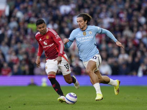 Manchester, England, 6th April 2025. Jack Grealish of Manchester City brought down by Casemiro of Manchester United, ManU during the Manchester United vs Manchester City Premier League match at Old Trafford, Manchester. Picture credit should read: Andrew Yates Sportimage EDITORIAL USE ONLY. No use with unauthorised audio, video, data, fixture lists, club league logos or live services. Online in-match use limited to 120 images, no video emulation. No use in betting, games or single club league player publications. SPI_046_AY_United_City SPI-3814-0047