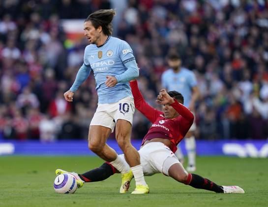 Manchester, England, 6th April 2025. Jack Grealish of Manchester City brought down by Casemiro of Manchester United, ManU during the Manchester United vs Manchester City Premier League match at Old Trafford, Manchester. Picture credit should read: Andrew Yates Sportimage EDITORIAL USE ONLY. No use with unauthorised audio, video, data, fixture lists, club league logos or live services. Online in-match use limited to 120 images, no video emulation. No use in betting, games or single club league player publications. SPI_047_AY_United_City SPI-3814-0048