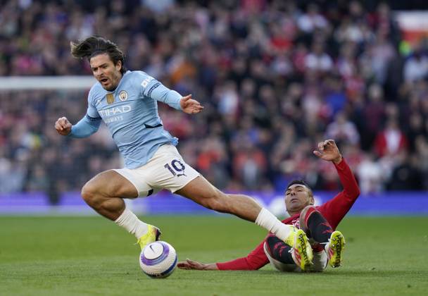 Manchester, England, 6th April 2025. Jack Grealish of Manchester City brought down by Casemiro of Manchester United, ManU during the Manchester United vs Manchester City Premier League match at Old Trafford, Manchester. Picture credit should read: Andrew Yates Sportimage EDITORIAL USE ONLY. No use with unauthorised audio, video, data, fixture lists, club league logos or live services. Online in-match use limited to 120 images, no video emulation. No use in betting, games or single club league player publications. SPI_048_AY_United_City SPI-3814-0049