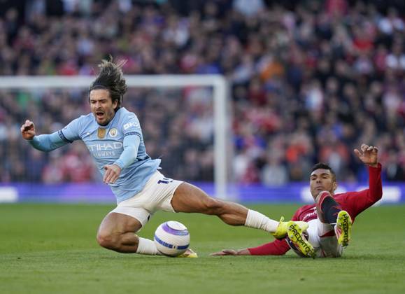 Manchester, England, 6th April 2025. Jack Grealish of Manchester City brought down by Casemiro of Manchester United, ManU during the Manchester United vs Manchester City Premier League match at Old Trafford, Manchester. Picture credit should read: Andrew Yates Sportimage EDITORIAL USE ONLY. No use with unauthorised audio, video, data, fixture lists, club league logos or live services. Online in-match use limited to 120 images, no video emulation. No use in betting, games or single club league player publications. SPI_049_AY_United_City SPI-3814-0050