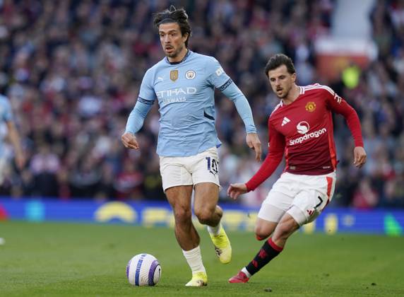 Manchester, England, 6th April 2025. Jack Grealish of Manchester City (L) is challenged by Mason Mount of Manchester United, ManU during the Manchester United vs Manchester City Premier League match at Old Trafford, Manchester. Picture credit should read: Andrew Yates Sportimage EDITORIAL USE ONLY. No use with unauthorised audio, video, data, fixture lists, club league logos or live services. Online in-match use limited to 120 images, no video emulation. No use in betting, games or single club league player publications. SPI_101_AY_United_City SPI-3814-0102