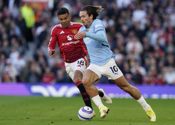 Manchester, England, 6th April 2025. Jack Grealish of Manchester City (R) is challenged by Casemiro of Manchester United, ManU during the Manchester United vs Manchester City Premier League match at Old Trafford, Manchester. Picture credit should read: Andrew Yates Sportimage EDITORIAL USE ONLY. No use with unauthorised audio, video, data, fixture lists, club league logos or live services. Online in-match use limited to 120 images, no video emulation. No use in betting, games or single club league player publications. SPI_107_AY_United_City SPI-3814-0108