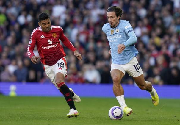 Manchester, England, 6th April 2025. Jack Grealish of Manchester City (R) is challenged by Casemiro of Manchester United, ManU during the Manchester United vs Manchester City Premier League match at Old Trafford, Manchester. Picture credit should read: Andrew Yates Sportimage EDITORIAL USE ONLY. No use with unauthorised audio, video, data, fixture lists, club league logos or live services. Online in-match use limited to 120 images, no video emulation. No use in betting, games or single club league player publications. SPI_108_AY_United_City SPI-3814-0109