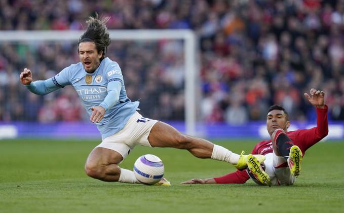 Manchester, England, 6th April 2025. Jack Grealish of Manchester City (L) is challenged by Casemiro of Manchester United, ManU during the Manchester United vs Manchester City Premier League match at Old Trafford, Manchester. Picture credit should read: Andrew Yates Sportimage EDITORIAL USE ONLY. No use with unauthorised audio, video, data, fixture lists, club league logos or live services. Online in-match use limited to 120 images, no video emulation. No use in betting, games or single club league player publications. SPI_109_AY_United_City SPI-3814-0110