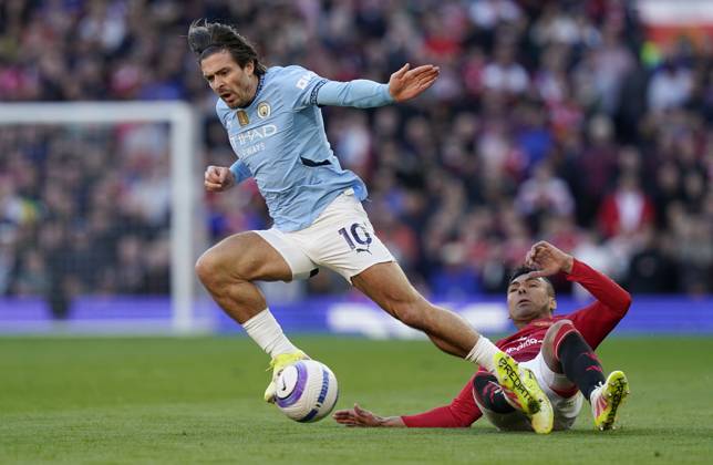 Manchester, England, 6th April 2025. Jack Grealish of Manchester City (L) is challenged by Casemiro of Manchester United, ManU during the Manchester United vs Manchester City Premier League match at Old Trafford, Manchester. Picture credit should read: Andrew Yates Sportimage EDITORIAL USE ONLY. No use with unauthorised audio, video, data, fixture lists, club league logos or live services. Online in-match use limited to 120 images, no video emulation. No use in betting, games or single club league player publications. SPI_110_AY_United_City SPI-3814-0111