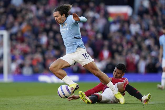 Manchester, England, 6th April 2025. Jack Grealish of Manchester City (L) is challenged by Casemiro of Manchester United, ManU during the Manchester United vs Manchester City Premier League match at Old Trafford, Manchester. Picture credit should read: Andrew Yates Sportimage EDITORIAL USE ONLY. No use with unauthorised audio, video, data, fixture lists, club league logos or live services. Online in-match use limited to 120 images, no video emulation. No use in betting, games or single club league player publications. SPI_111_AY_United_City SPI-3814-0112