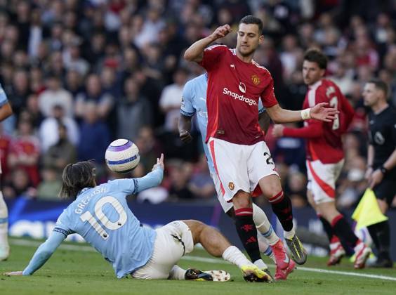 Manchester, England, 6th April 2025. Jack Grealish of Manchester City (L) challenges Diogo Dalot of Manchester United, ManU during the Manchester United vs Manchester City Premier League match at Old Trafford, Manchester. Picture credit should read: Andrew Yates Sportimage EDITORIAL USE ONLY. No use with unauthorised audio, video, data, fixture lists, club league logos or live services. Online in-match use limited to 120 images, no video emulation. No use in betting, games or single club league player publications. SPI_113_AY_United_City SPI-3814-0114