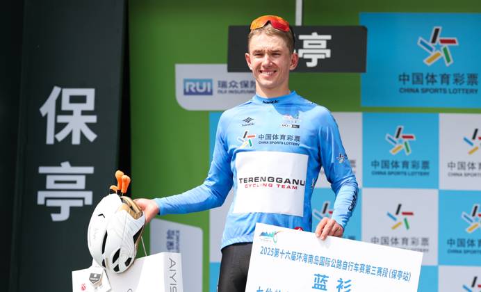 (250409) -- BAOTING, April 9, 2025 -- Vadim Pronskiy of Terengganu Cycling Team celebrates in the blue jersey during the awarding ceremony after Stage 3 at the 16th Tour of Hainan cycling race from Lingshui to Baoting, south China s Hainan Province, April 9, 2025. ) (SP)CHINA-HAINAN-BAOTING-CYCLING-TOUR OF HAINAN (CN) YangxGuanyu 