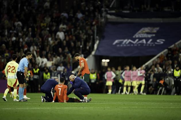 UEFA Nations League Final: Portugal vs Spain Cristiano Ronaldo of Portugal receives medical attention after sustaining an injury during the UEFA Nations League final against Spain at Allianz Arena in Munich. Copyright: xTaiseixIwamotox