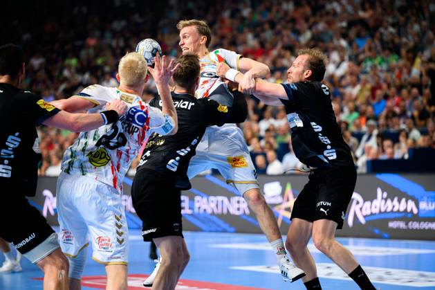 Cologne, Germany Handball EHF CL Final 4 Final Fuechse Berlin SC Magdeburg from left in duel Gisli Thorgeir Kristjansson SC Magdeburg and Max Darj Berlin , Magnus Saugstrup Jensen SC Magdeburg at the circle Cologne Lanxess Arena Nordrhein Westfalen Germany