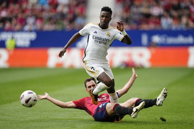 CA Osasuna v Real Madrid CF - LaLiga EA Sports PAMPLONA, SPAIN - MARCH 16: Vinicius Junior (top) left winger of Real Madrid and Brazil and Unai Garcia (ground) centre-back of Osasuna and Spain compete for the ball during the LaLiga EA Sports match between CA Osasuna and Real Madrid CF at Estadio El Sadar on March 16, 2024 in Pamplona, Spain. Spain World. Editorial use only. Please get in touch for any other usage.  Copyright: x2025xAnadoluxJosexHernandezx