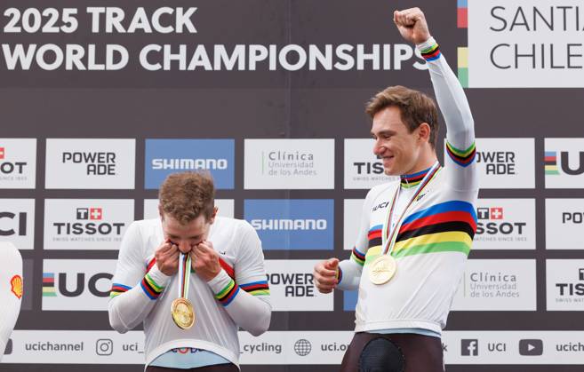 Belgian Fabio Van Den Bossche and Belgian Lindsay De Vylder celebrate celebrate on the podium with their gold medals and wearing the world champion jersey, on the podium of the podium ceremony of the men s Madison race at the 2025 UCI Track World Championships cycling, in Santiago, Chile, Sunday 26 October 2025. The Track World Championships take place from 22 to 26 October at the Velodromo de Penalolen in Santiago, Chile. BENOITxDOPPAGNE x138051484x