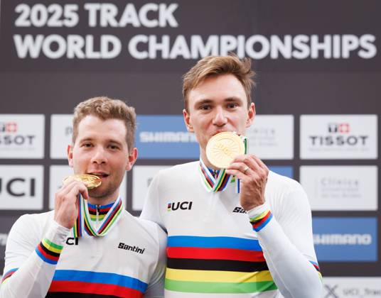 Belgian Fabio Van Den Bossche and Belgian Lindsay De Vylder celebrate celebrate on the podium with their gold medals and wearing the world champion jersey, on the podium of the podium ceremony of the men s Madison race at the 2025 UCI Track World Championships cycling, in Santiago, Chile, Sunday 26 October 2025. The Track World Championships take place from 22 to 26 October at the Velodromo de Penalolen in Santiago, Chile. BENOITxDOPPAGNE x138051491x