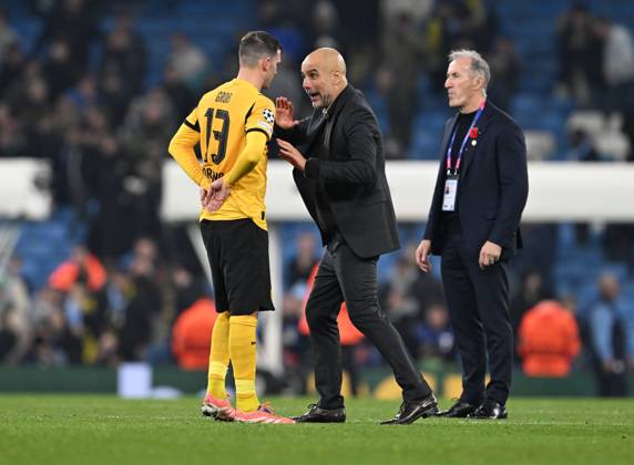 Manchester, England, 5th November 2025. Pep Guardiola coach of Manchester City coaching Pascal Gross of Borussia Dortmund on the final whistle during the Manchester City vs Borussia Dortmund UEFA Champions League match at the Etihad Stadium, Manchester. Picture credit should read: Cody Froggatt Sportimage EDITORIAL USE ONLY. No use with unauthorised audio, video, data, fixture lists, club league logos or live services. Online in-match use limited to 120 images, no video emulation. No use in betting, games or single club league player publications. SPI_066_CF_Man_City_Dortmund SPI-4268-0128