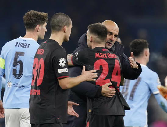 Manchester, England, 25th November 2025. Pep Guardiola coach of Manchester City congratulates Aleix Garcia of Bayer Leverkusen during the Manchester City vs Bayer Leverkusen UEFA Champions League match at the Etihad Stadium, Manchester. Picture credit should read: Andrew Yates Sportimage EDITORIAL USE ONLY. No use with unauthorised audio, video, data, fixture lists, club league logos or live services. Online in-match use limited to 120 images, no video emulation. No use in betting, games or single club league player publications. SPI_074_AY_Man_City_Leverkusen SPI-4309-0110