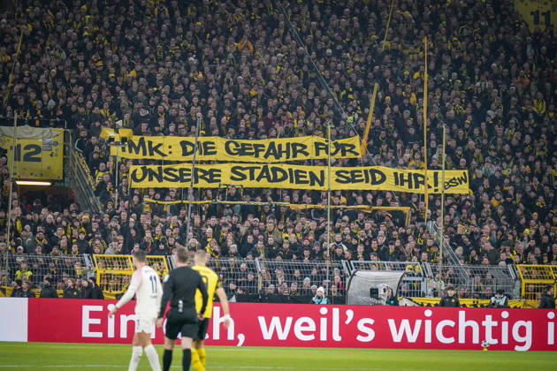 Germany Football DFB Cup 2025 26, Round of 16 Borussia Dortmund vs Bayer 04 Leverkusen Signal Iduna Park Dortmund Large protest banner of BVB fans IMK The danger for our stadiums is you Topics Conference of Interior Ministers, stadium security, fan protests, fan culture, political debate, security policy, transparency, soccer society, Bundesliga, home match crowd, emotional south stand, expression of opinion, public discussion, sports politics, social tensions Dortmund North Rhine-Westphalia Germany Copyright: xJOERANxSTEINSIEKx