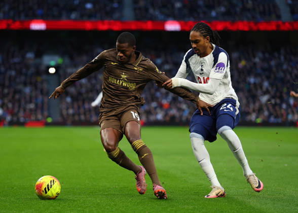 6th December 2025; Tottenham Hotspur Stadium, London, England; Premier League Football, Tottenham Hotspur versus Brentford; Dango Ouattara of Brentford challenged by Djed Spence of Tottenham Hotspur  JohnxPatrickxFletcher