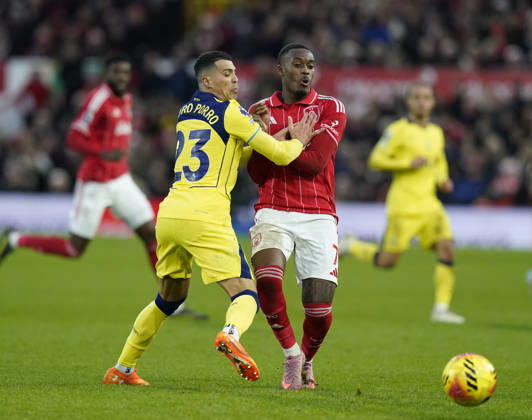 Nottingham, England, 14th December 2025. IPedro Porro of Tottenham challenges Callum Hudson-Odoi of Nottingham Forest during the Nottingham Forest vs Tottenham Hotspur Premier League match at the City Ground, Nottingham. Picture credit should read: Andrew Yates Sportimage EDITORIAL USE ONLY. No use with unauthorised audio, video, data, fixture lists, club league logos or live services. Online in-match use limited to 120 images, no video emulation. No use in betting, games or single club league player publications. SPI_081_AY_Forest_Spurs SPI-4376-0081