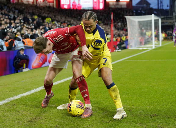 Nottingham, England, 14th December 2025. Elliot Anderson of Nottingham Forest tussles with Xavi Simons of Tottenham during the Nottingham Forest vs Tottenham Hotspur Premier League match at the City Ground, Nottingham. Picture credit should read: Andrew Yates Sportimage EDITORIAL USE ONLY. No use with unauthorised audio, video, data, fixture lists, club league logos or live services. Online in-match use limited to 120 images, no video emulation. No use in betting, games or single club league player publications. SPI_083_AY_Forest_Spurs SPI-4376-0083