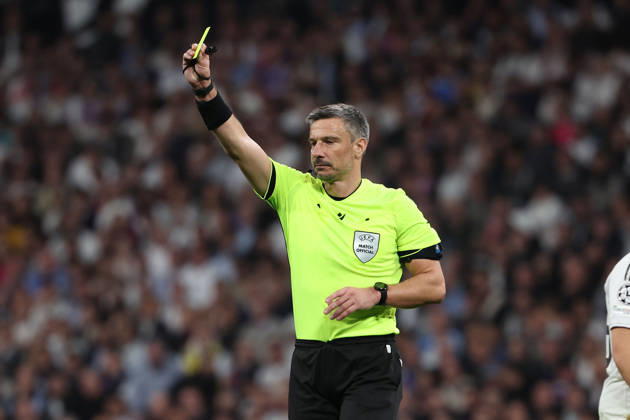 Madrid, Spain February 25, 2026 FBL UEFA Champions League 2025 26 Real Madrid SL Benfica referee Slavko Vincic SVN shows a yellow card during the UEFA Champions League 2025 26 knockout play offs match between Real Madrid and SL Benfica at the Santiago Bernabà u Stadium on February 25, 2026 in Madrid, Spain Copyright: JoaquimxFerreira