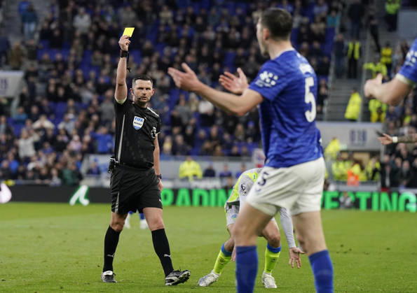 Liverpool, England, 4th May 2026. Referee Michael Oliver issues a yellow card fo Michael Keane of Everton for a tackle on Jeremy Doku of Manchester City during the Everton vs Manchester City Premier League match at Hill Dickinson Stadium, Liverpool. Picture credit should read: Andrew Yates Sportimage EDITORIAL USE ONLY. No use with unauthorised audio, video, data, fixture lists, club league logos or live services. Online in-match use limited to 120 images, no video emulation. No use in betting, games or single club league player publications. SPI_023_AY_Everton_Man_City SPI-4779-0023