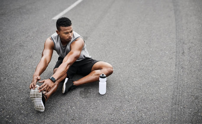 His determination is unfaltering. a sporty young man stretching his legs while exercising outdoors (License=RF) 20287126 ,model released, Symbolfoto  Copyright: xZoonar.com YurixArcursxpeopleimages.comx 20287126 ,model released, Symbolfoto ,property released