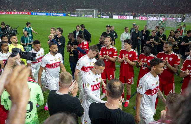 Soccer, men, 2025 2026 season, 83 DFB Cup final, FC Bayern Munich VfB Stuttgart 3 0 , from l Harry Kane Bayern Munich , Min jae Kim Bayern Munich , Jonathan Tah Bayern Munich , stand in the winners line for the Stuttgart players, 23 05 2026, Copyright: xMatthiasxKochx