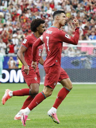 Football: 2026 World Cup Portugal s Cristiano Ronaldo (R) celebrates after scoring the opening goal in the first half of a World Cup Group K football match against Uzbekistan at Houston Stadium in Houston on June 23, 2026.  A14AA0005620007P