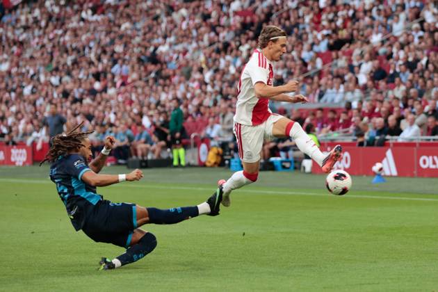 AMSTERDAM , 06-08-2026, Johan Cruijff ArenA , season 2026 2027 , UEFA Conference League play-off football . Match between Ajax and Shelbourne FC , Picture shows Shelbourne FC player Milan Mbeng, Ajax player Mika Godts Ajax - Shelbourne x205489017x Copyright: