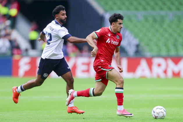 Berkay Isik of SV Hemelingen and Husseyn Chakroun of Hannover 96 battle for the ball during the DFB Cup match between SV Hemelingen and Hannover 96 at Weserstadion on August 22, 2026, in Bremen, Germany Photo by Marco Steinbrenner, DeFodi Images Berkay Isik of SV Hemelingen and Husseyn Chakroun of Hannover 96 battle for the ball during the DFB Cup match between SV Hemelingen and Hannover 96 at Weserstadion on August 22, 2026 in Bremen, Germany. Photo by Marco Steinbrenner, DeFodi Images. Photo by Marco Steinbrenner, DeFodi Images.