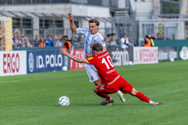 Battle for the Ball: Tackle between Julian Bell (TSV 1860 Munich, No. 02) and Jonas Therkelsen (Holstein Kiel, No. 10), GER, TSV 1860 Munich vs. Holstein Kiel, Soccer, DFB Cup, 1st Round, 2026–2027 Season, August 22, 2026 DFL and DFB regulations prohibit any use of photographs as image sequences and or quasi-video. Photo: HMB Media, Heike Feiner Copyright: HMBxMedia HeikexFeiner