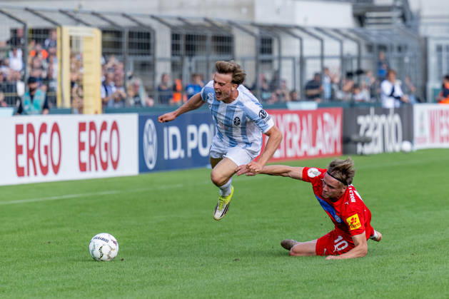 Julian Bell of TSV 1860 Munich, No. 02, is fouled here by Jonas Therkelsen of Holstein Kiel, No. 10, GER, TSV 1860 Munich vs. Holstein Kiel, Soccer, DFB Cup, 1st Round, 2026–2027 Season, August 22, 2026 DFL and DFB regulations prohibit any use of photographs as image sequences and or quasi-video. Photo: HMB Media, Heike Feiner Copyright: HMBxMedia HeikexFeiner