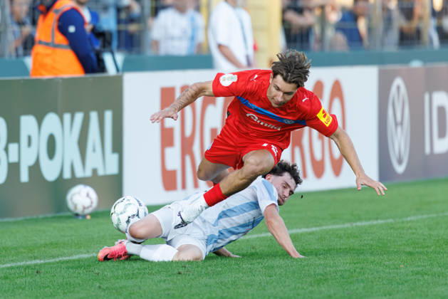 Moritz Reimers, 22, Holstein Kiel, and Lance Fiedler, 47, TSV 1860 Munich, during the match between TSV 1860 Munich and Holstein Kiel, soccer, men s, DFB Cup, 2026–2027, Round 1 on August 22, 2026, in Munich, Städtisches Stadion an der Grünwalder Straße, Bavaria, Germany