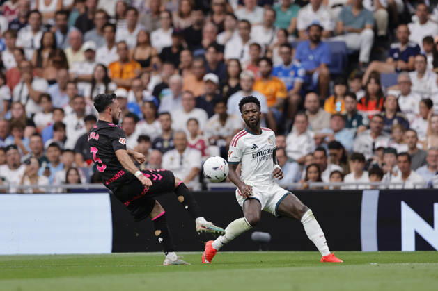 Vinicius Jr. of Real Madrid CF and Carlos Puga of Málaga CF battle for the ball during the LaLiga EA Sports match between Real Madrid CF and Málaga CF at Estadio Santiago Bernabéu on August 30, 2026, in Madrid, Spain. Photo by Manu Reino, DeFodi Images