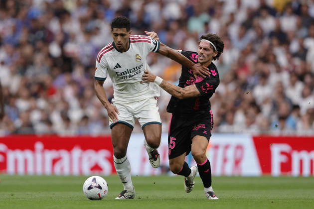 Jude Bellingham of Real Madrid CF and Angel Recio of Málaga CF battle for the ball during the LaLiga EA Sports match between Real Madrid CF and Málaga CF at Estadio Santiago Bernabéu on August 30, 2026, in Madrid, Spain. Photo by Manu Reino, DeFodi Images