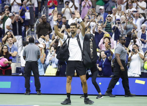 Fans watch Novak Djokovic of Serbia recast as he walks off of the court after his match against Mariano Navone of Argentina in Arthur Ashe Stadium in the first round at the 2026 US Open Tennis Championship at the USTA Billie Jean King National Tennis Center in New York City on Sunday, August 30, 2026. Navone defeated Djokovic in 5 sets.  NYP20260830154 JOHNxANGELILLO