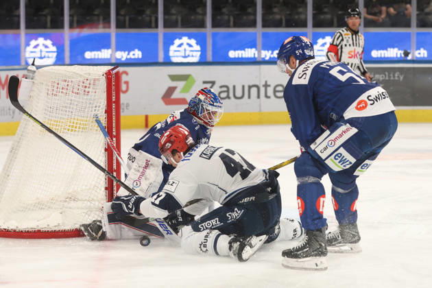 September 3, 2026, Zurich, SWITZERLAND, Swiss Life Arena, 2026–2027 Ice Hockey Season, Exhibition Game: ZSC Lions vs. Schwenninger Wild Wings, Alexander Karachun (Wild) vs. Christian Marti (ZSC Lions) in front of goaltender Robin Zumbuehl (ZSC Lions)